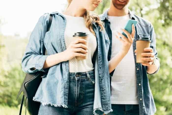 couple drinking coffee with phone