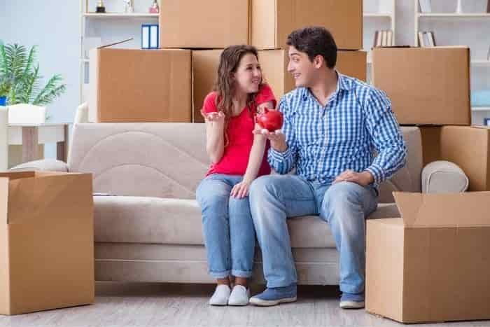 Young pair moving in to new house with boxes