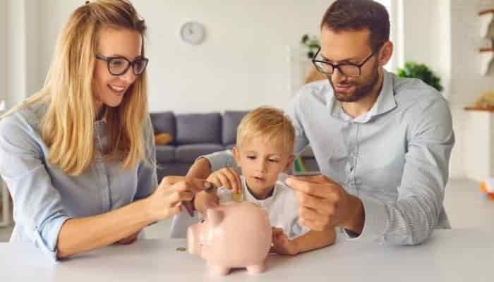 young family saving with piggy bank