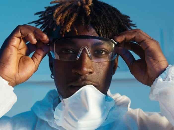 technician in lab suit with goggles