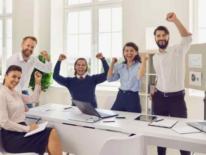 smartly dressed group of people cheering