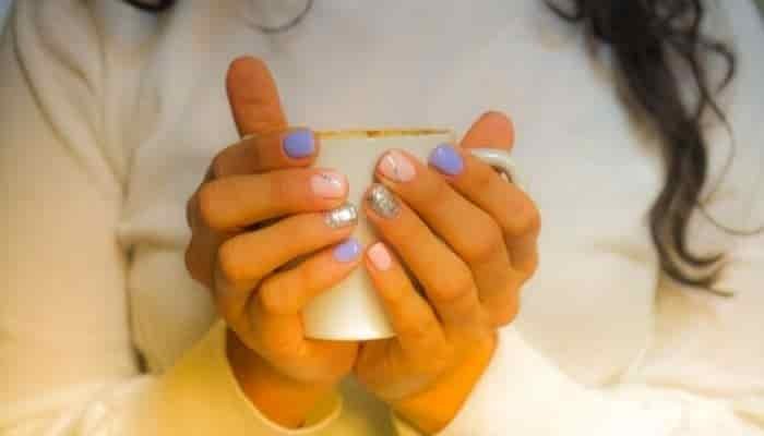 woman's hands holding a mug