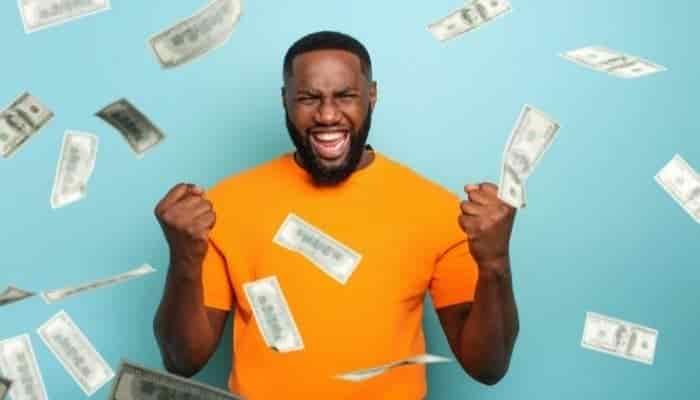 bank notes falling around a man