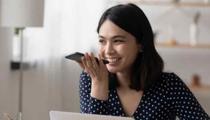smiling woman talking on a phone using handsfree