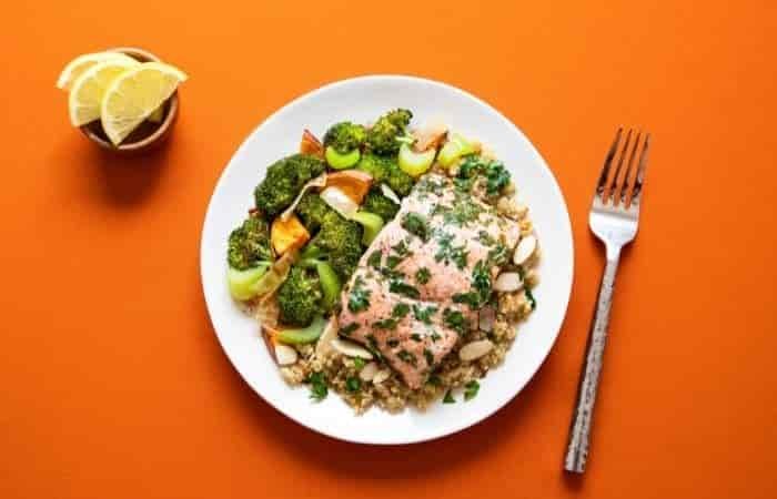 salmon and qunioa on an orange background