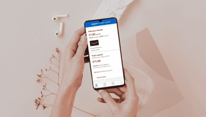 hands holding phone showing amazon shopper panel app