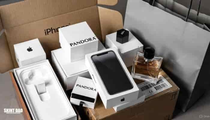 A selection of empty designer boxes, tech boxes and perfume bottles arranged together to show how they can be sold for extra money.