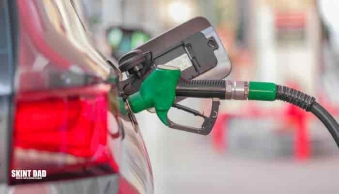 fuel pump filling a red car